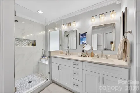 a bathroom with a granite countertop sink mirror and double
