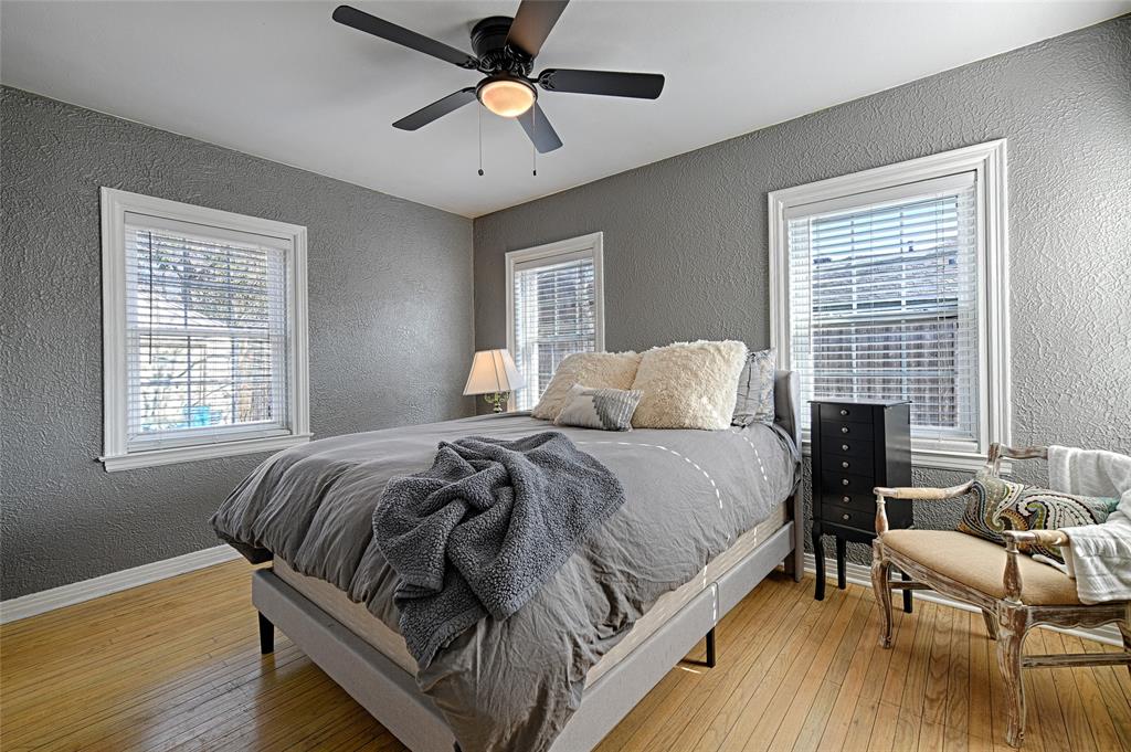 1707 Homewood Place Dallas, TX 75224 - Photo 11 of 21 a bedroom with a bed and wooden floor
