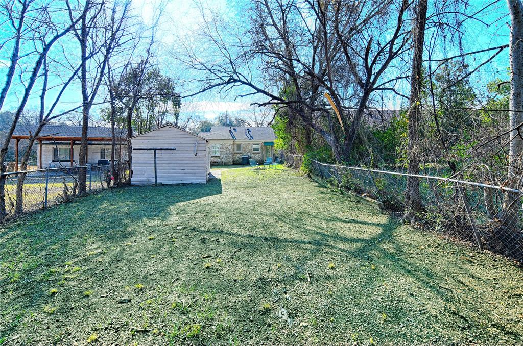 1707 Homewood Place Dallas, TX 75224 - Photo 19 of 21 a view of a house with backyard and a tree