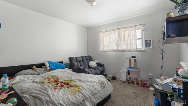 a bedroom with bed and a window