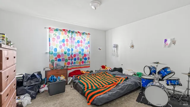 a backyard of a house with table and chairs a barbeque with potted plants