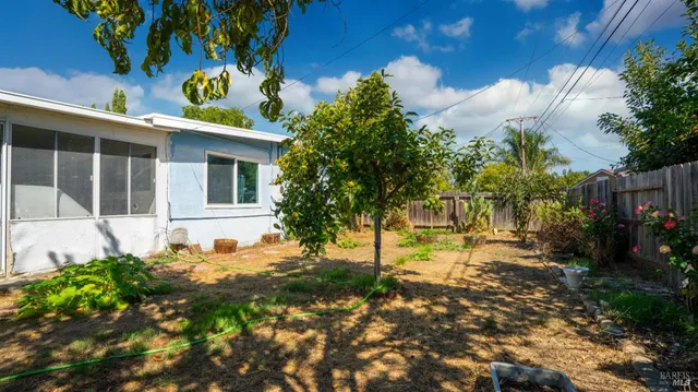a view of a house with backyard and sitting area