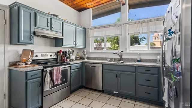 a kitchen with stainless steel appliances granite countertop a sink and a stove