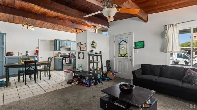 a living room with lots of furniture and a dining table
