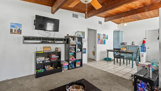a view of a livingroom with furniture and a flat screen tv