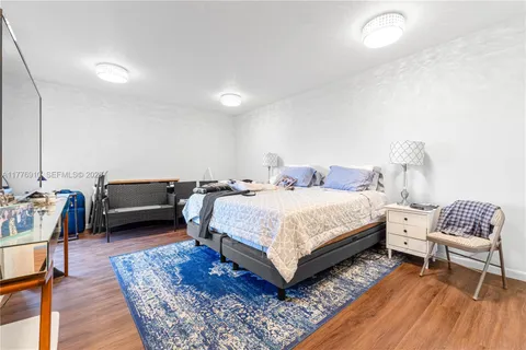 a bedroom with a bed a couch and a dresser