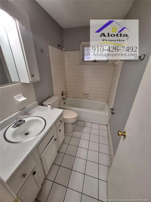 819 Ridge Road, Unit B Fayetteville, NC 28311 - Photo 3 of 7 a bathroom with a sink a toilet and a mirror