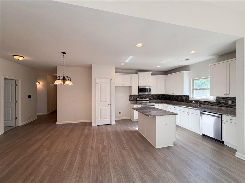 4075 McClendon Way Rex, GA 30273 - Photo 10 of 25 a kitchen with a white stove top oven and refrigerator