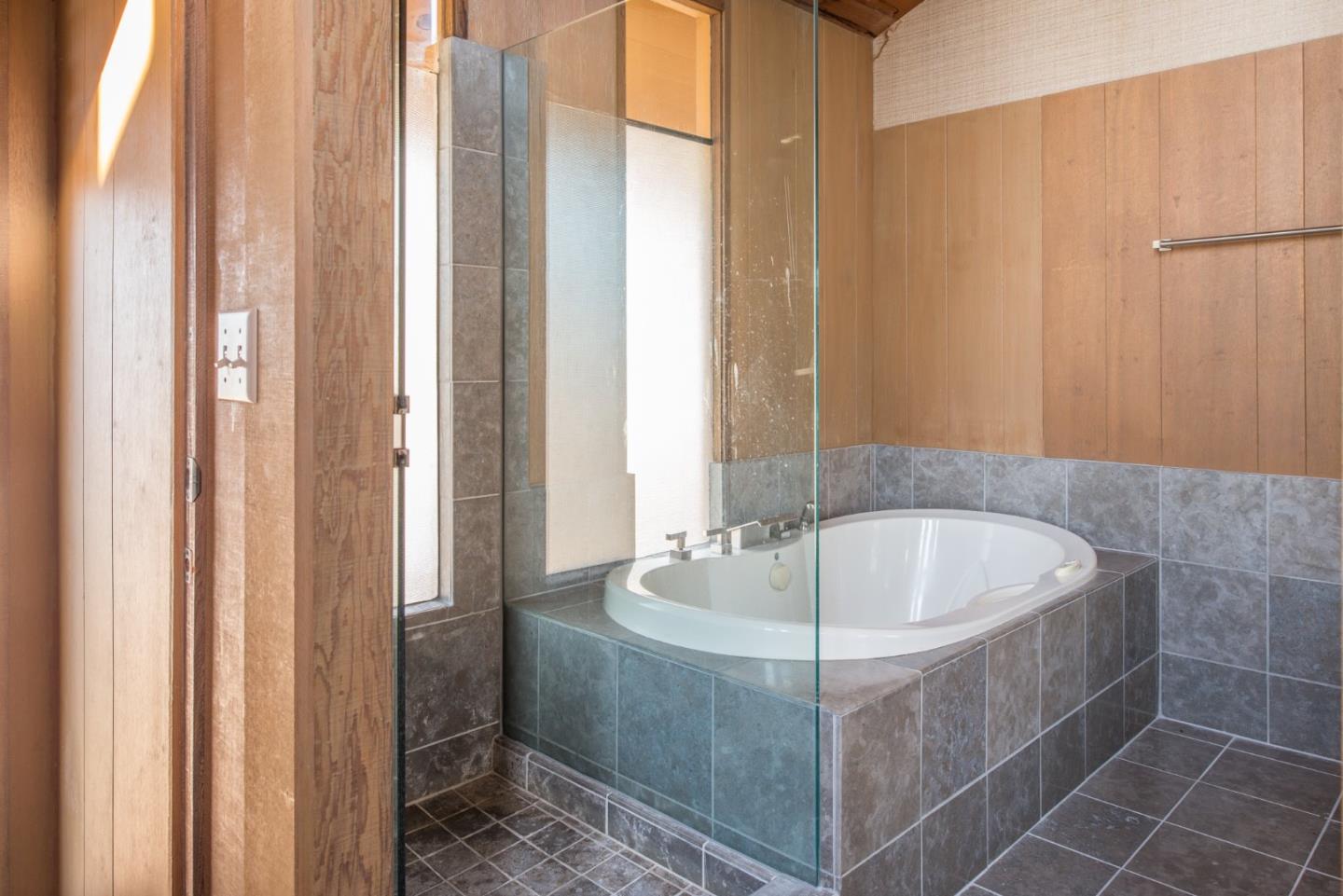 3044 Cormorant Road Pebble Beach, CA 93953 - Photo 17 of 49 a bath tub sitting in a bathroom next to a sink