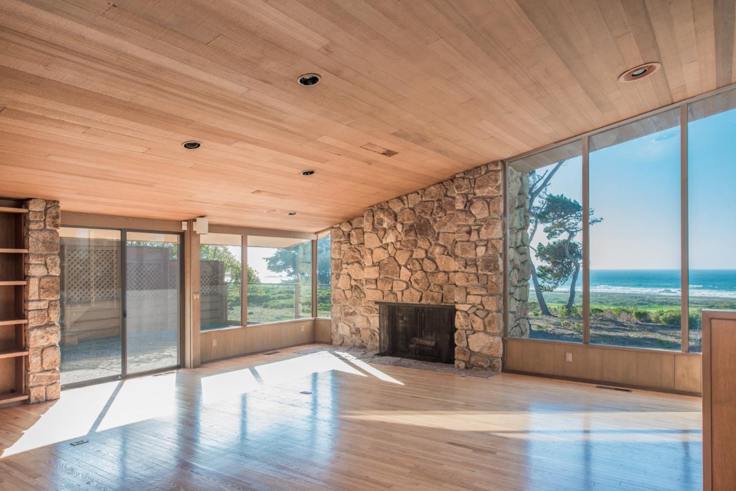 3044 Cormorant Road Pebble Beach, CA 93953 - Photo 20 of 49 a view of empty room with wooden floor and fireplace