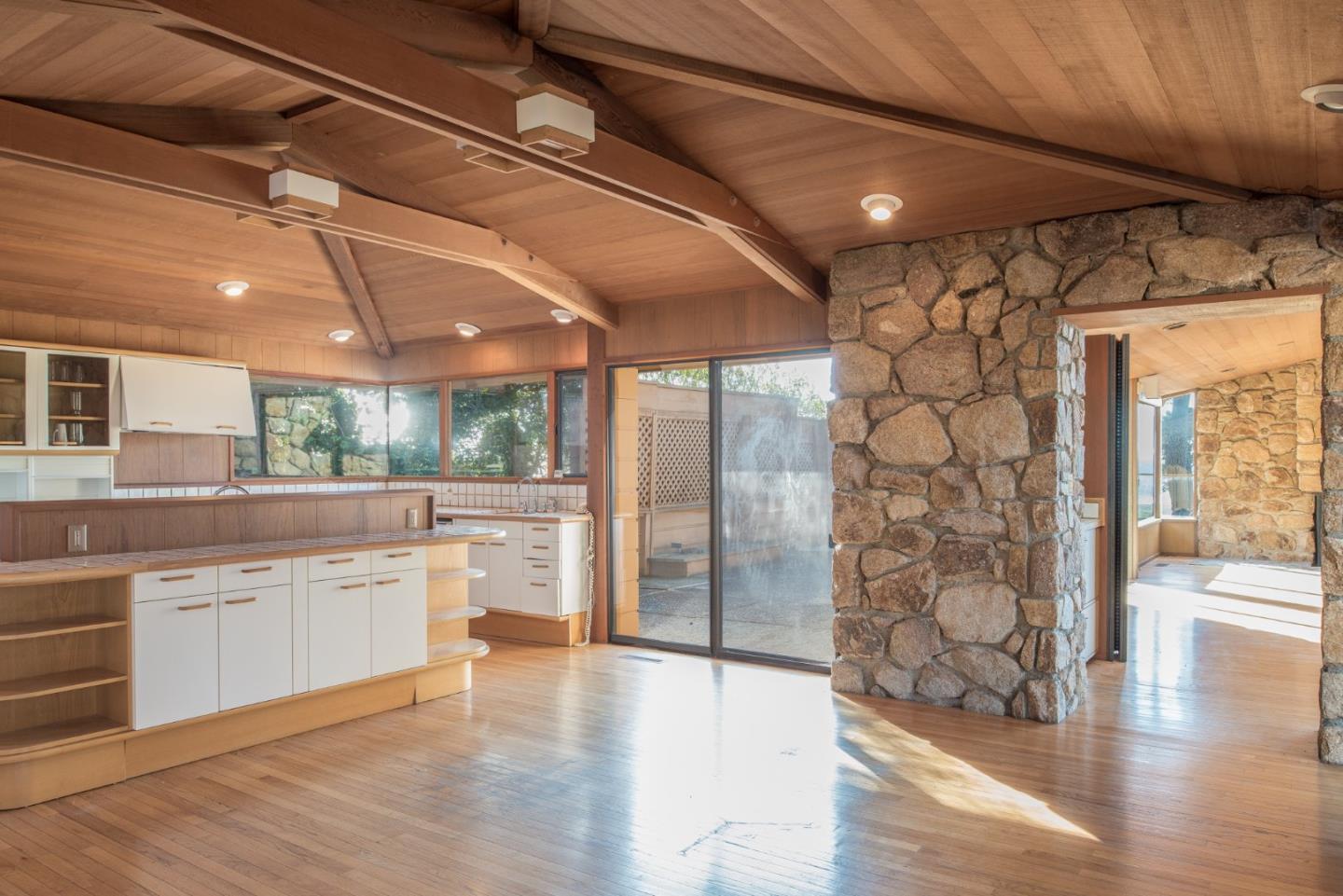 3044 Cormorant Road Pebble Beach, CA 93953 - Photo 26 of 49 a large kitchen with lot of wooden cabinets and glass door
