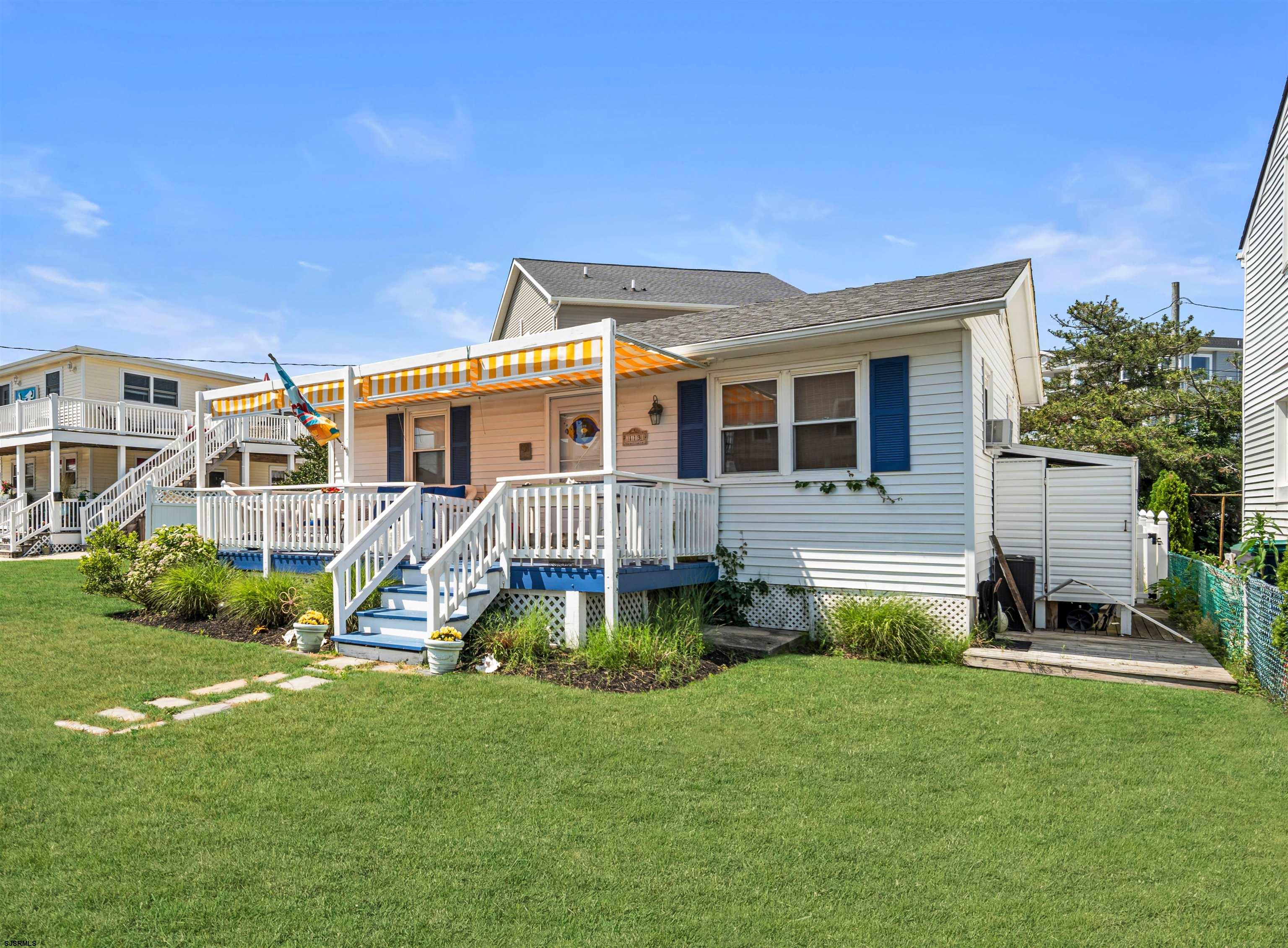 a view of a house with a backyard and a patio
