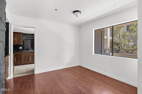 a view of hallway with a large window and wooden floor