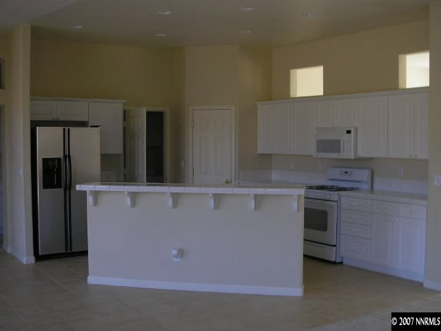 9553 Steep Climb Court Reno, NV 89521 - Photo 6 of 9 a kitchen with cabinets and stainless steel appliances