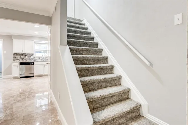 a view of staircase with white walls and windows