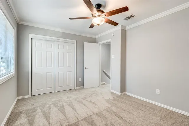 a view of a livingroom with a ceiling fan & window