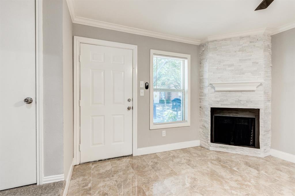 210 Rolston Road, Unit 8 Irving, TX 75060 - Photo 4 of 24 a view of an empty room with window and fire place