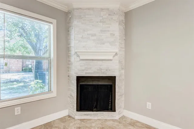 a living room with a fireplace and windows