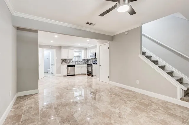 a view of a kitchen with a sink stainless steel appliances and cabinets