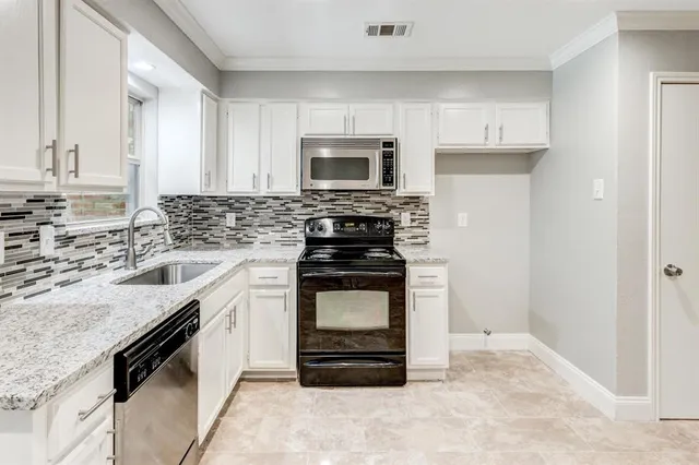 a kitchen with a stove and a microwave