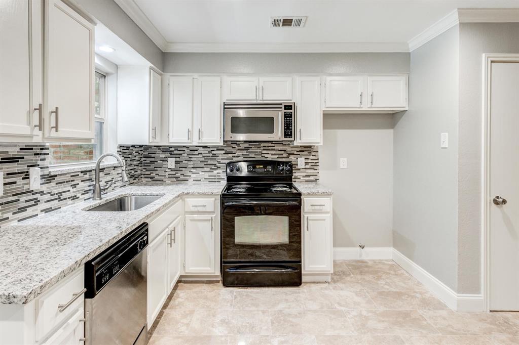 210 Rolston Road, Unit 8 Irving, TX 75060 - Photo 10 of 24 a kitchen with a stove and a microwave