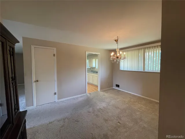 a kitchen with stainless steel appliances white cabinets and wooden floor