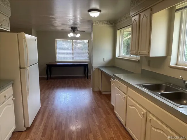 a kitchen with a refrigerator stove and sink
