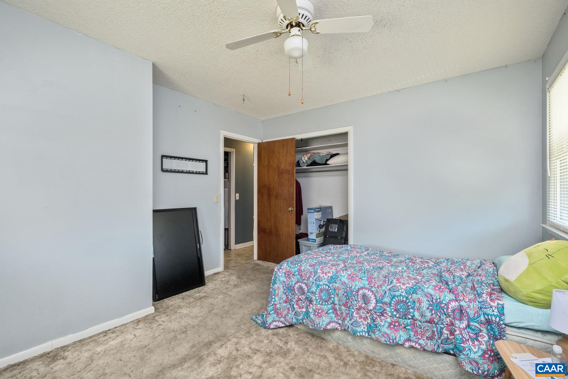 182 Clinton Street Harrisonburg, VA 22802 - Photo 16 of 21 a bedroom with a bed and a chandelier