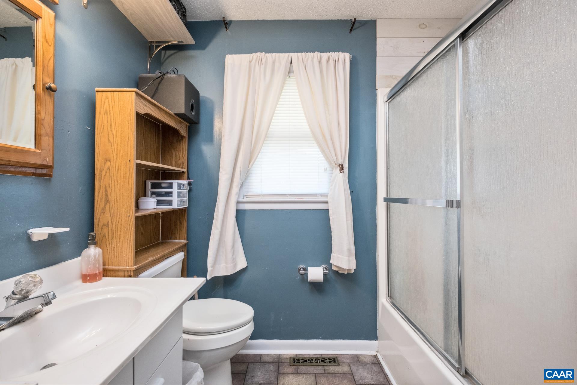 182 Clinton Street Harrisonburg, VA 22802 - Photo 17 of 21 a bathroom with a sink toilet and shower
