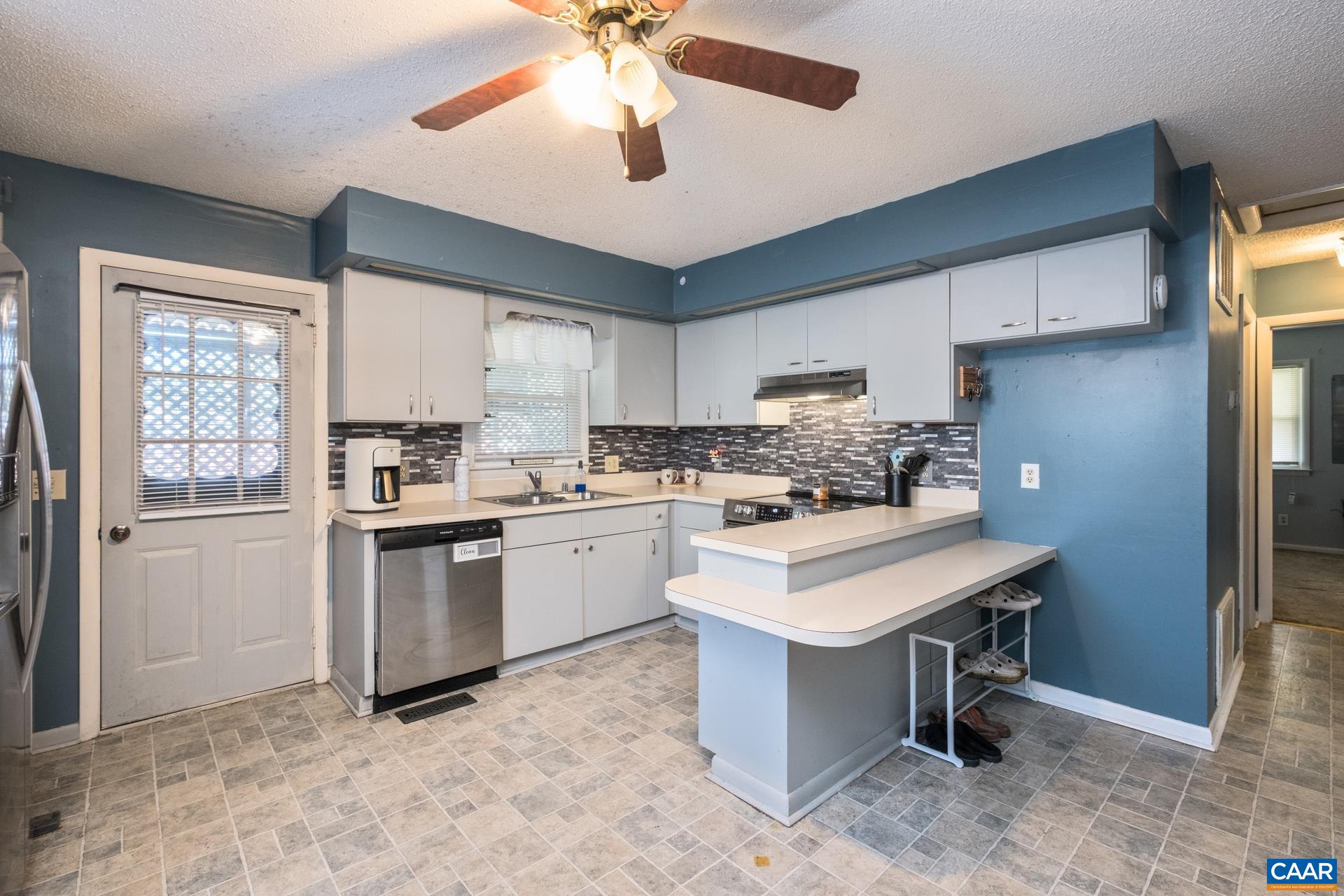 182 Clinton Street Harrisonburg, VA 22802 - Photo 4 of 21 a kitchen with a refrigerator sink and cabinets