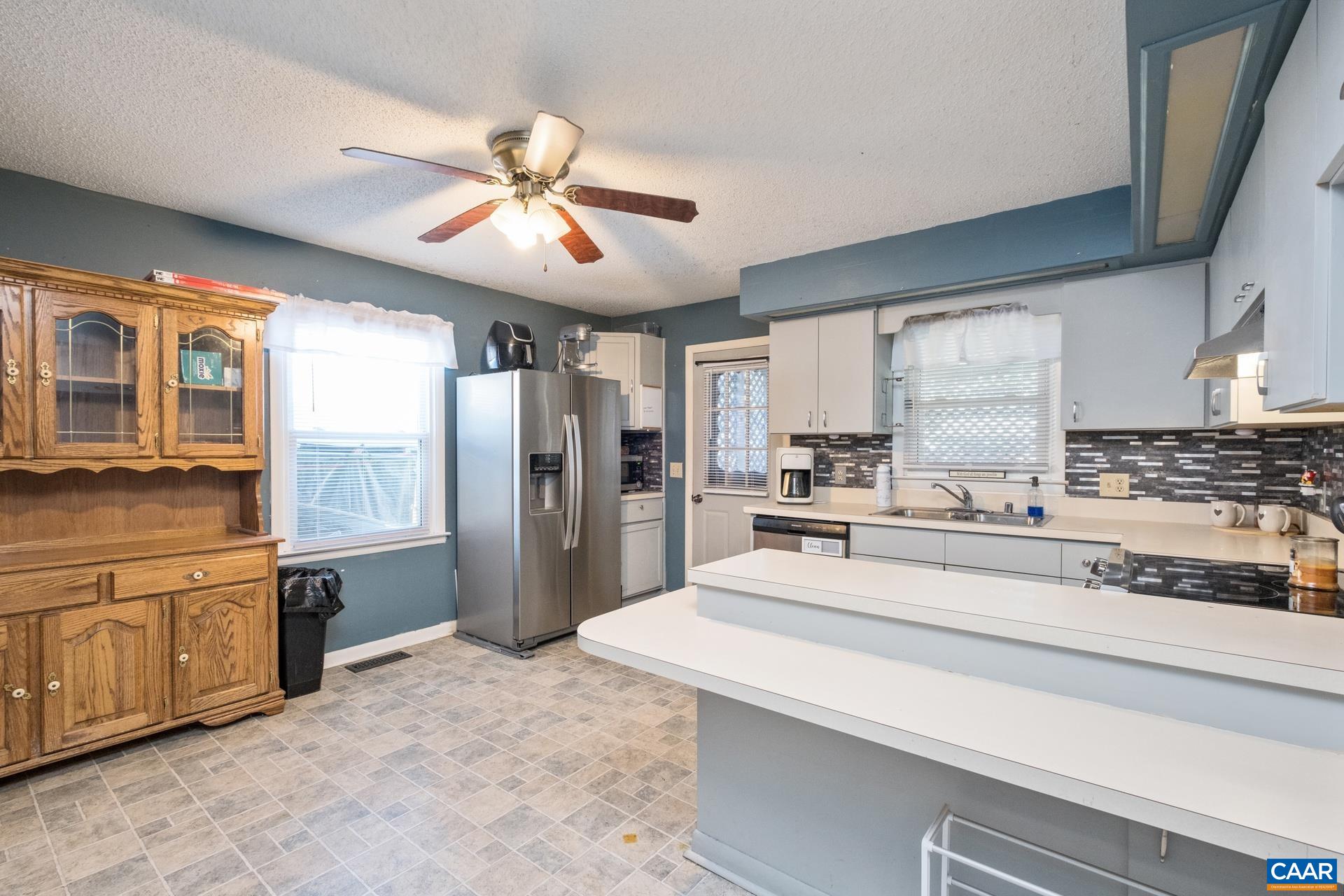 182 Clinton Street Harrisonburg, VA 22802 - Photo 5 of 21 a kitchen with stainless steel appliances kitchen island granite countertop a refrigerator a stove and a sink with cabinets