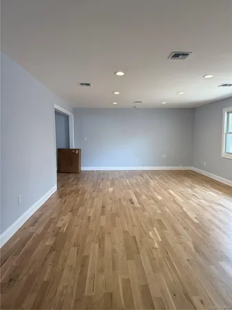 an empty room with wooden floor