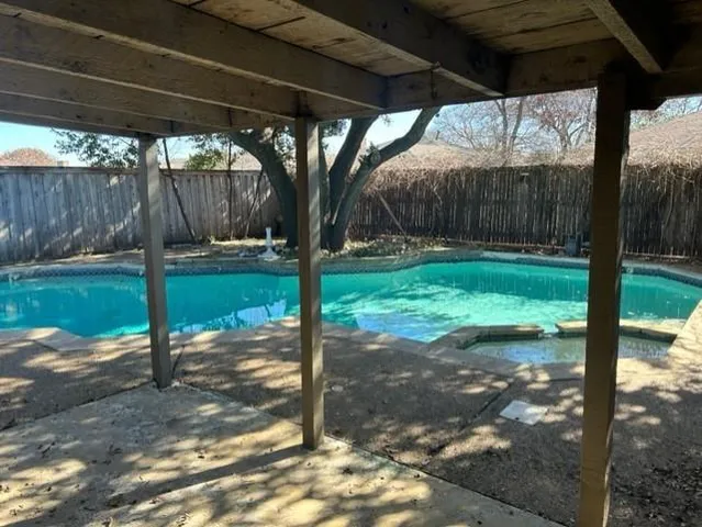 a view of a backyard with tree