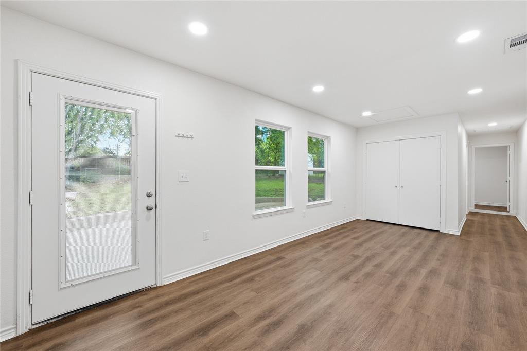 3227 Proctor Avenue Waco, TX 76708 - Photo 11 of 23 an empty room with wooden floor and windows