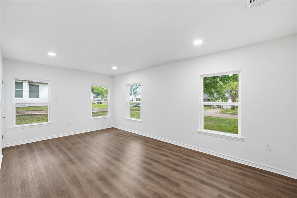 3227 Proctor Avenue Waco, TX 76708 - Photo 14 of 23 a view of an empty room with wooden floor and a window