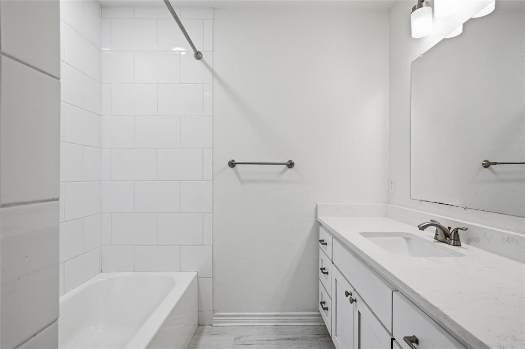 3227 Proctor Avenue Waco, TX 76708 - Photo 15 of 23 a bathroom with a bathtub sink vanity and mirror