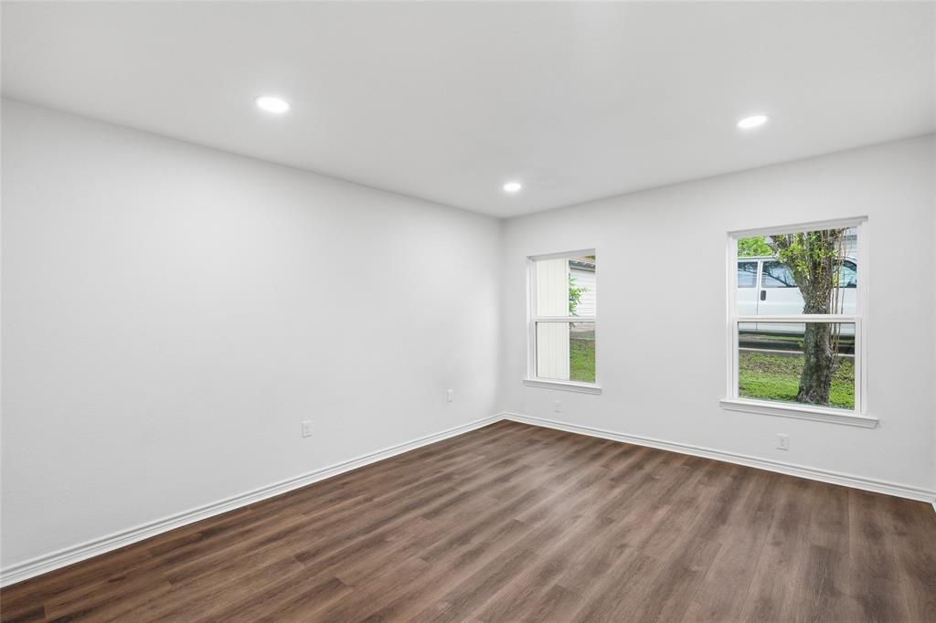 3227 Proctor Avenue Waco, TX 76708 - Photo 18 of 23 an empty room with wooden floor and windows