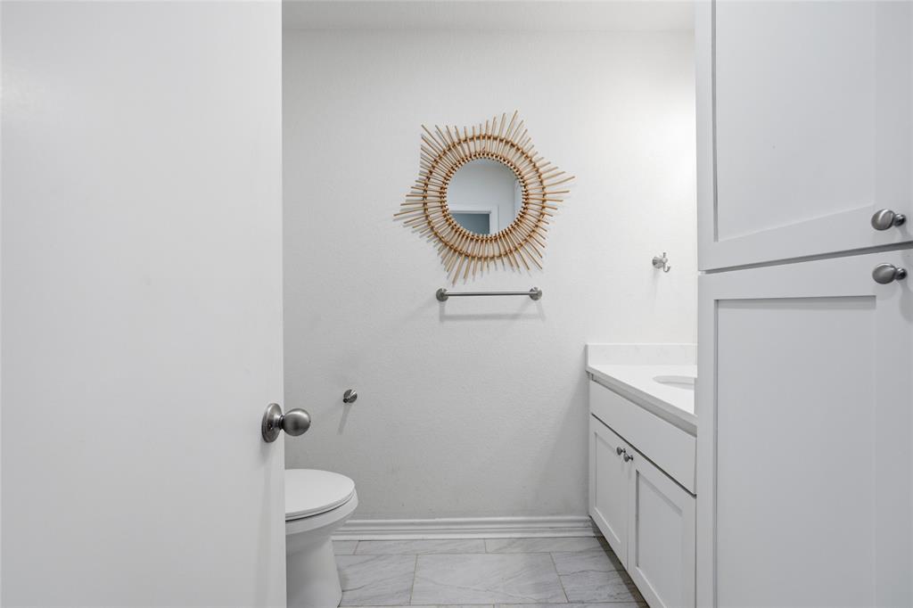 3227 Proctor Avenue Waco, TX 76708 - Photo 19 of 23 a bathroom with a granite countertop sink and a mirror