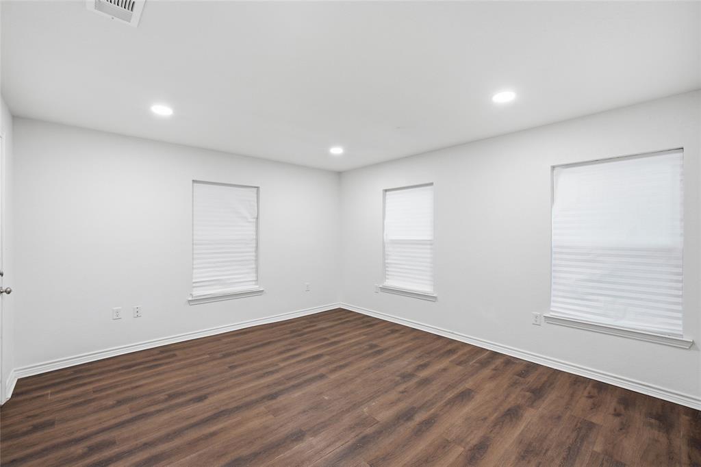 3227 Proctor Avenue Waco, TX 76708 - Photo 21 of 23 an empty room with wooden floor and windows