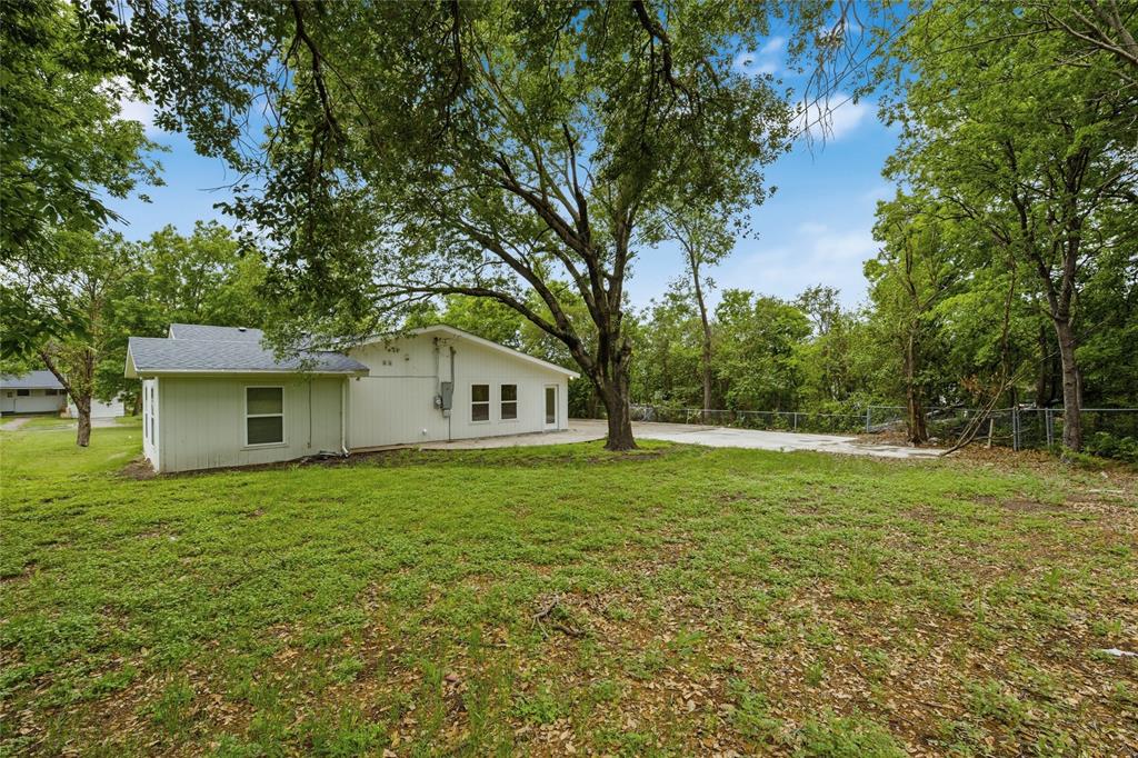 3227 Proctor Avenue Waco, TX 76708 - Photo 22 of 23 a house with huge green field in front of it