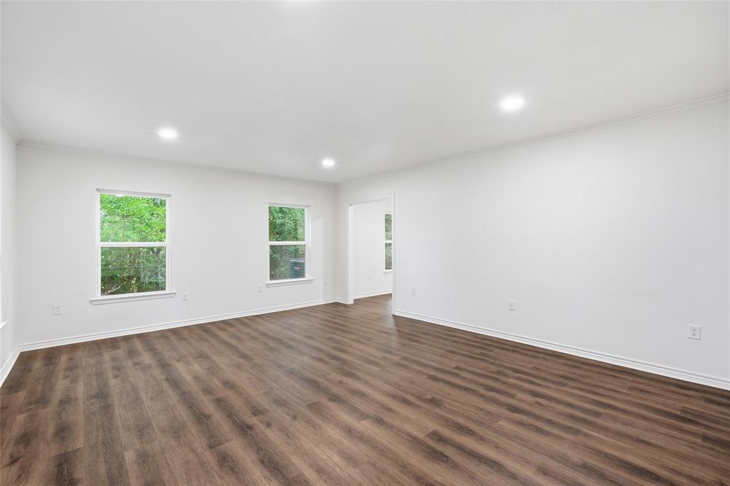 3227 Proctor Avenue Waco, TX 76708 - Photo 3 of 23 an empty room with wooden floor and windows