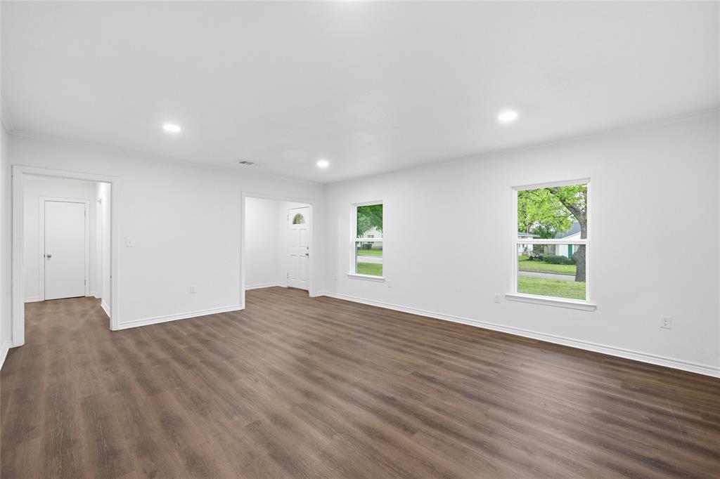 3227 Proctor Avenue Waco, TX 76708 - Photo 4 of 23 a view of an empty room with wooden floor and a window