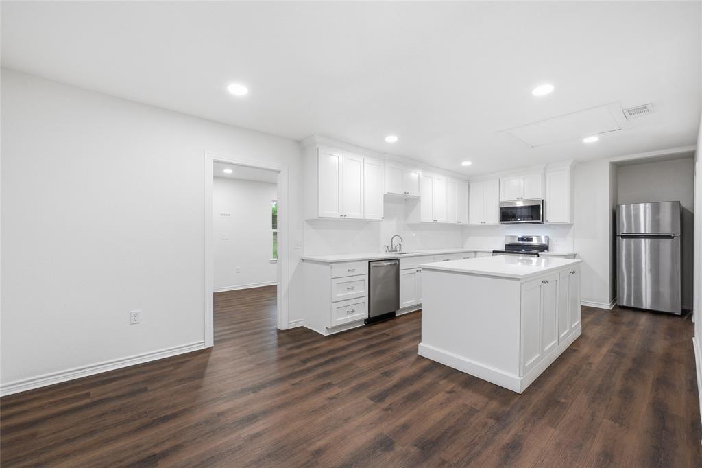 3227 Proctor Avenue Waco, TX 76708 - Photo 5 of 23 a kitchen with white cabinets white stainless steel appliances and sink