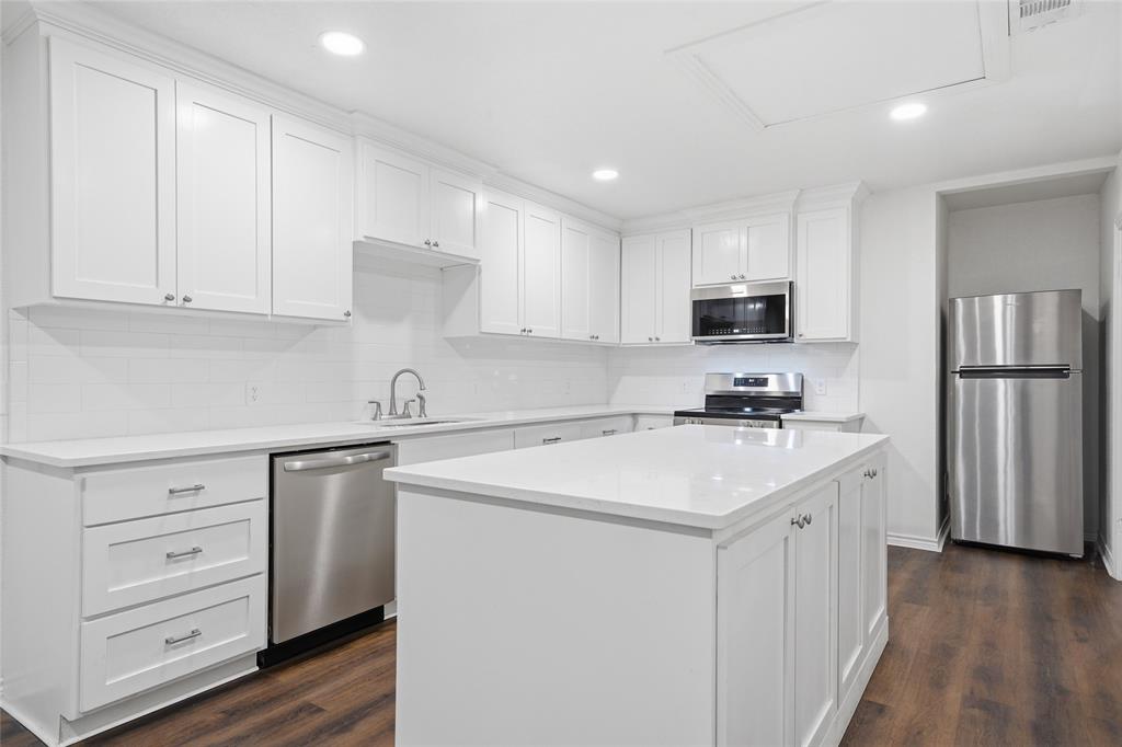 3227 Proctor Avenue Waco, TX 76708 - Photo 7 of 23 a kitchen with a sink a stove a refrigerator and cabinets