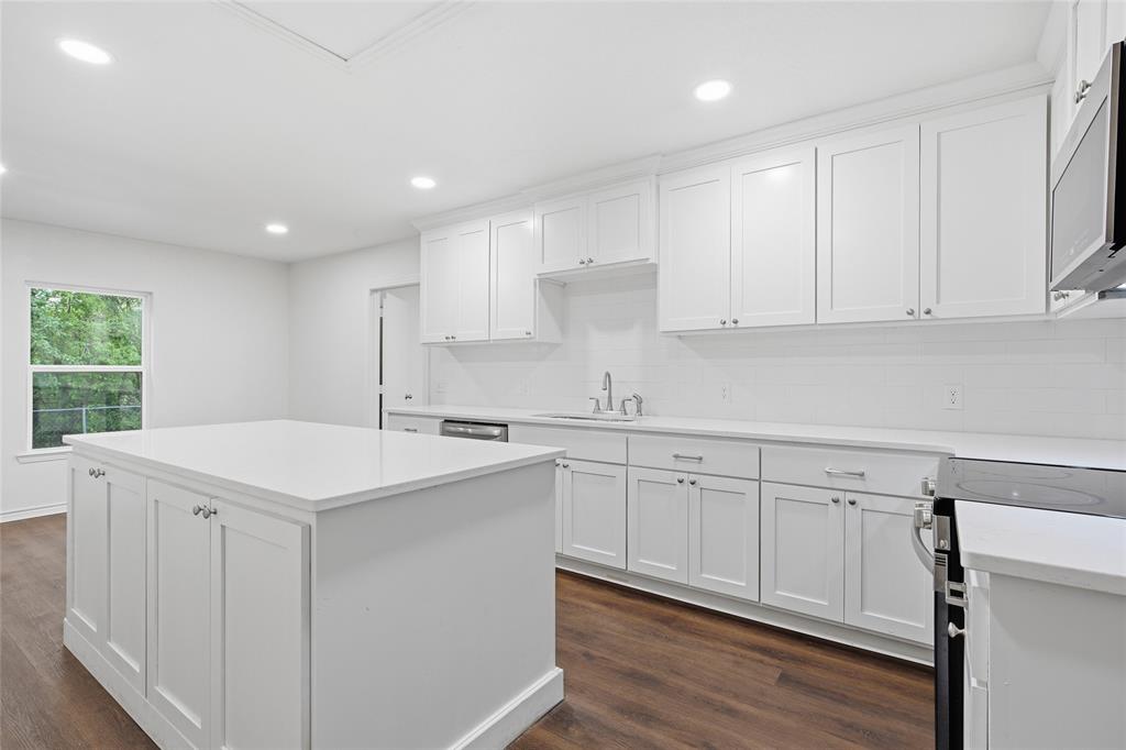 3227 Proctor Avenue Waco, TX 76708 - Photo 10 of 23 a kitchen with a sink window and cabinets