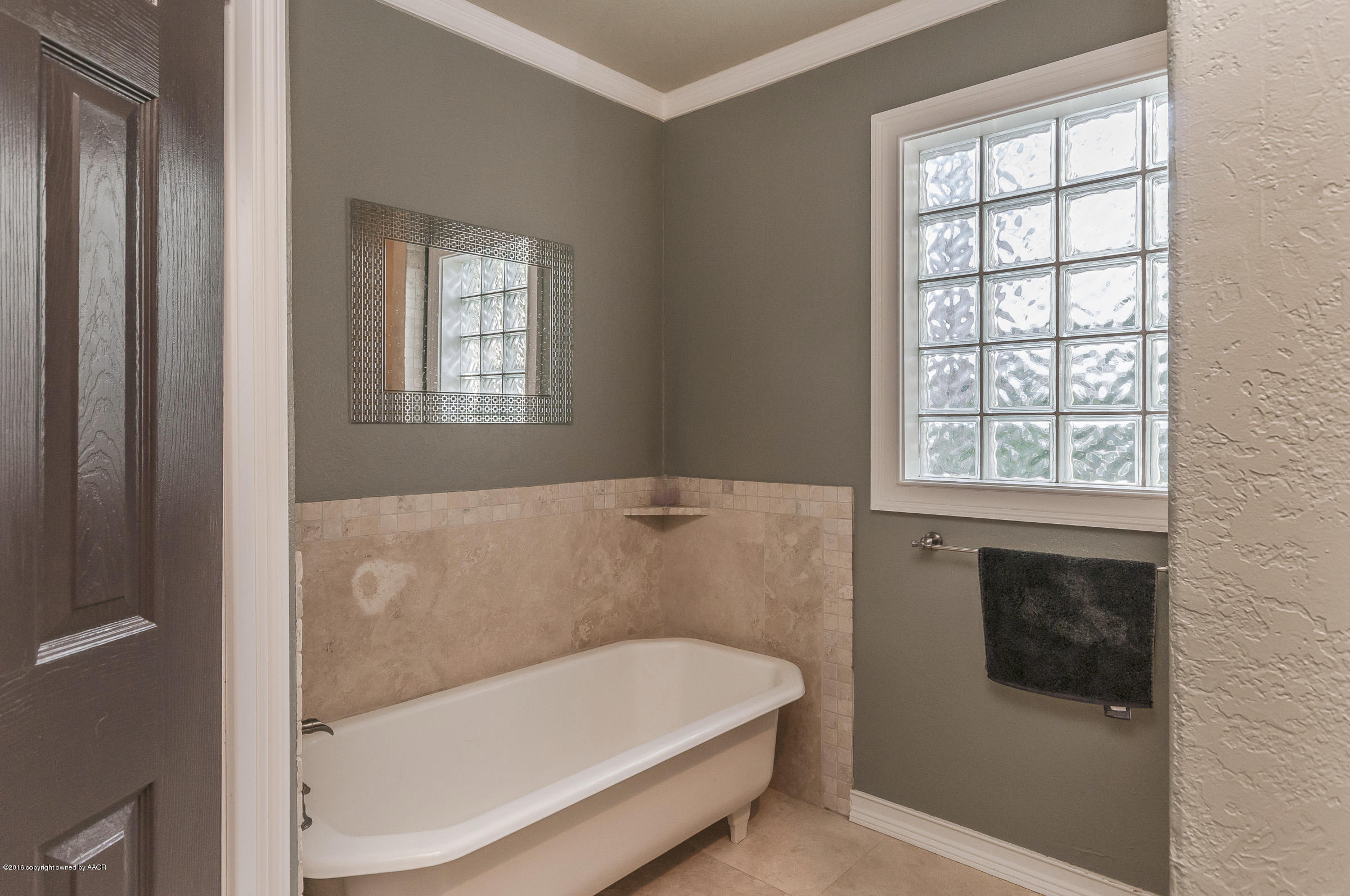 2208 South Lipscomb Street Amarillo, TX 79109 - Photo 12 of 18 a bath tub sitting in a bathroom next to a window