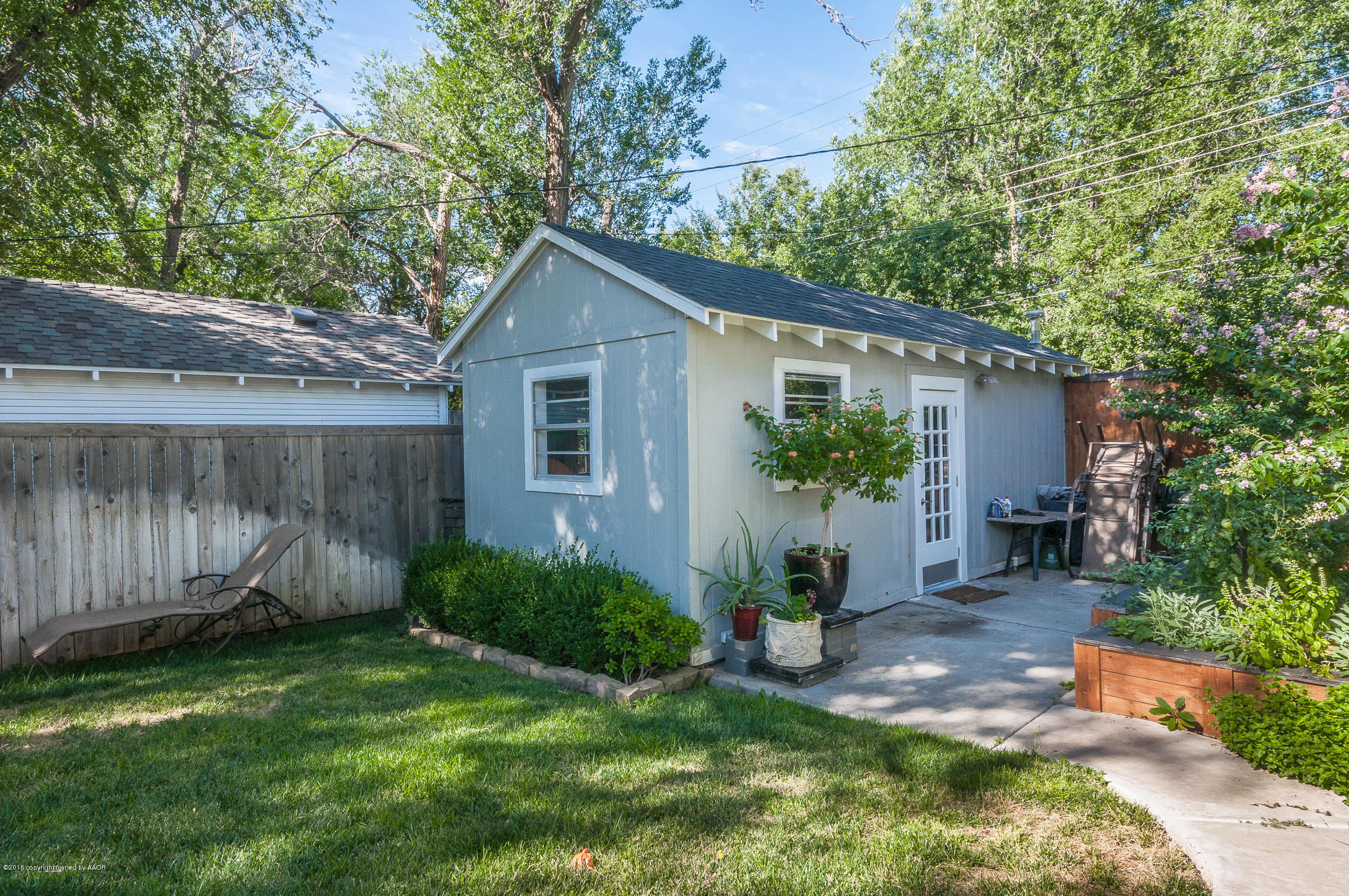 2208 South Lipscomb Street Amarillo, TX 79109 - Photo 13 of 18 a view of backyard with potted plants and a large tree