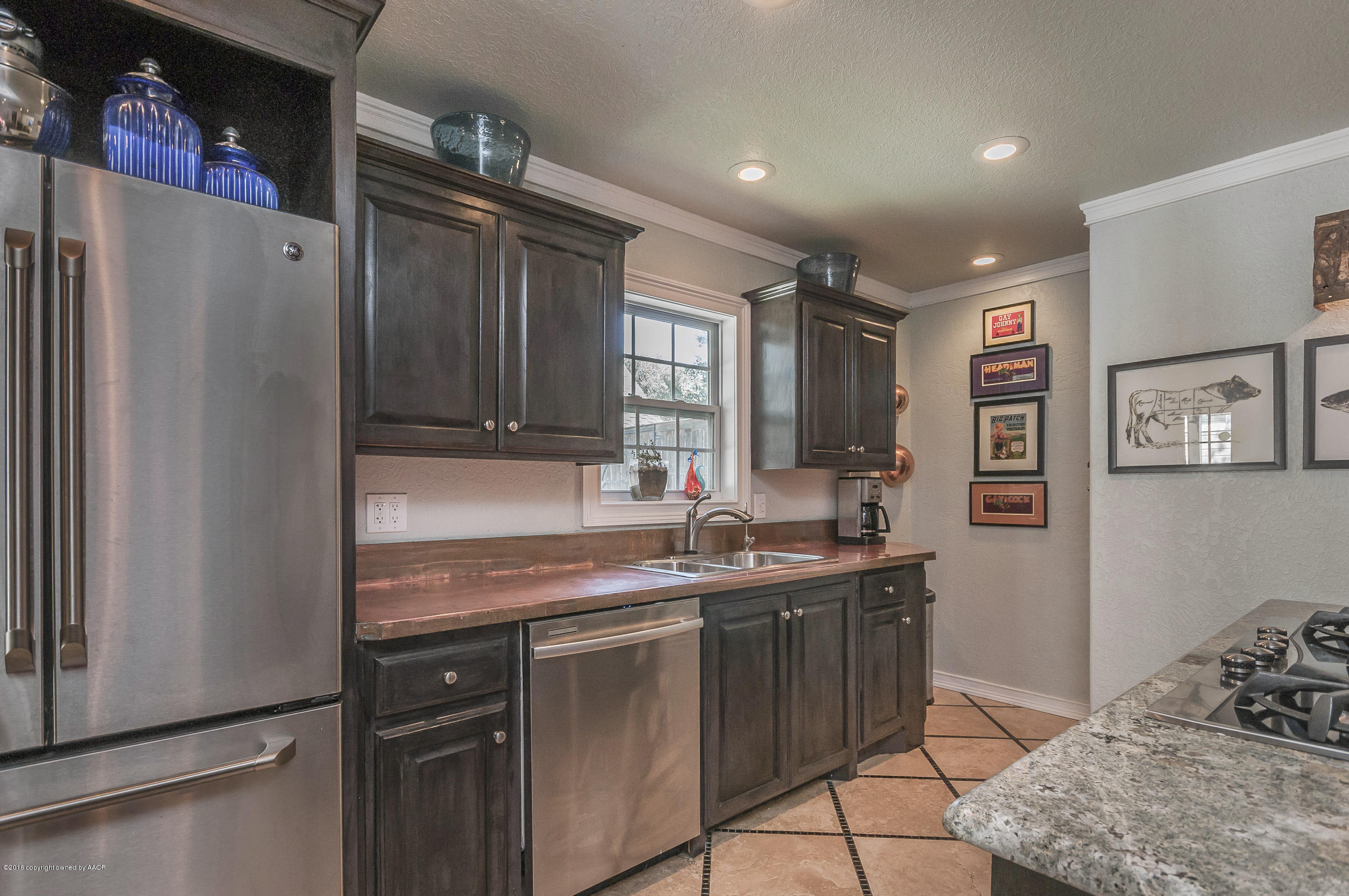 2208 South Lipscomb Street Amarillo, TX 79109 - Photo 6 of 18 a kitchen with stainless steel appliances granite countertop a refrigerator and a sink