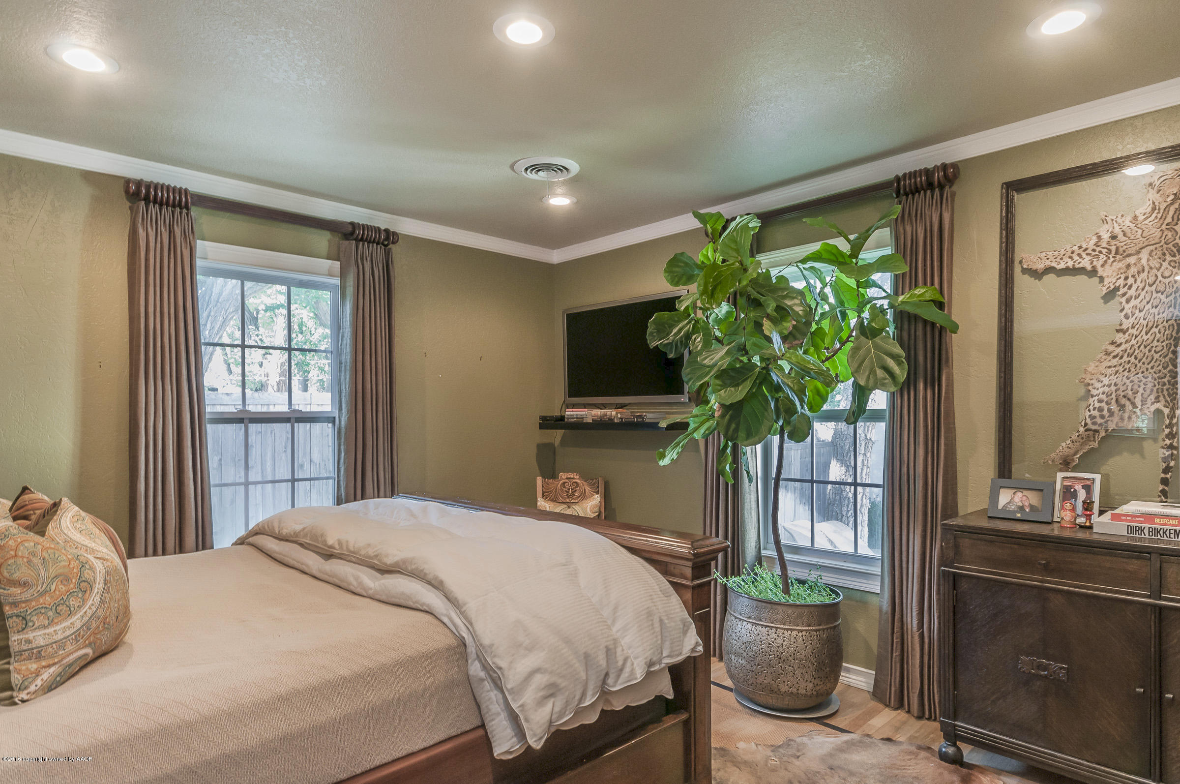 2208 South Lipscomb Street Amarillo, TX 79109 - Photo 9 of 18 a bedroom with a bed and a potted plant