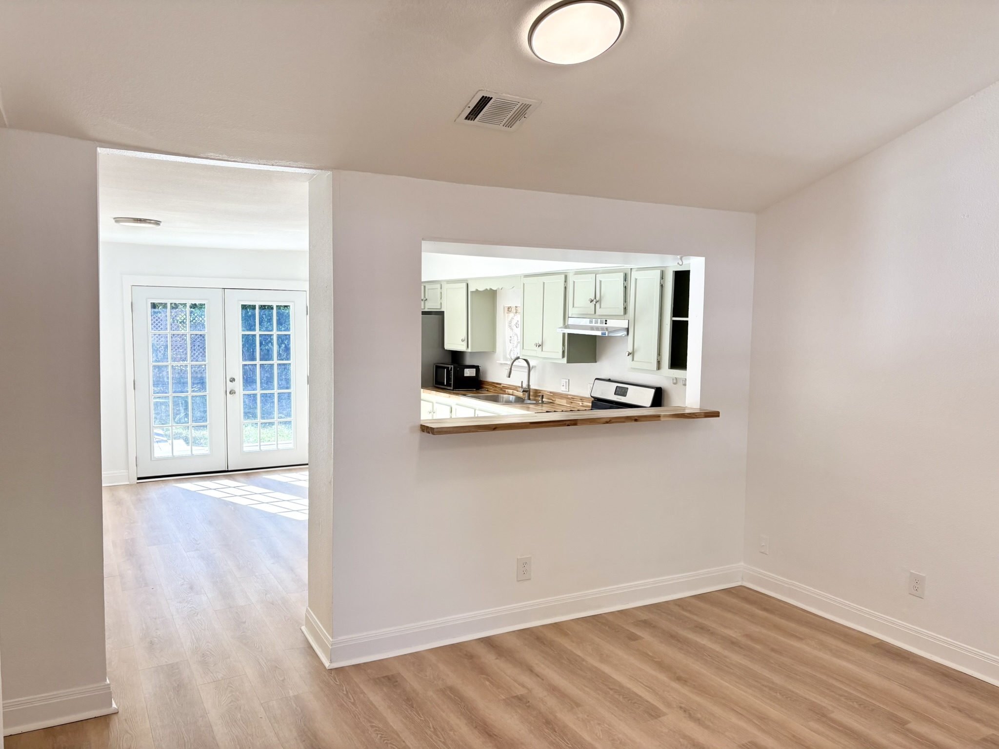 Undisclosed Address Austin, TX 78721 - Photo 6 of 28 A breakfast bar opening links the dining area directly to the kitchen.